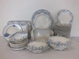 a lot of plates and bowls sitting on a table