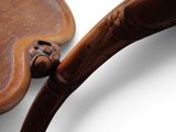 a wooden spoon with a handle on a white surface