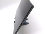 a tablet computer sitting on a stand on a white surface