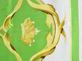 a picture of a green and white table cloth with a gold design