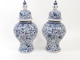 two blue and white vases sitting next to each other