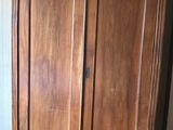 a large wooden cabinet in the corner of a room