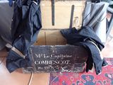 a wooden box with clothes on top of it on the floor