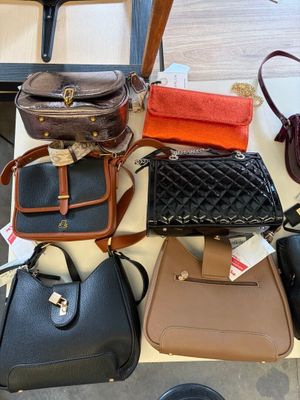 a lot of purses that are on a table
