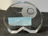 a clear glass award with a picture of a person on it