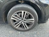 a black car with a flat tire on the street