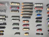 many different types of toy trains on the table
