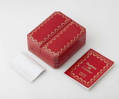 two red boxes with gold designs on them sitting on a white surface
