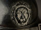 a close up of a helmet with a lion head on it