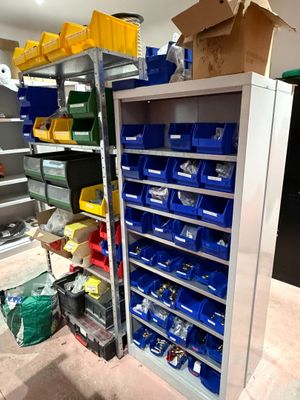 many bins and boxes on the shelves in the garage