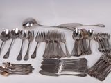 a lot of silverware on a white table