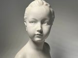 an image of a white busturine of a child on a black base