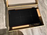 a box with a laptop inside of it on the floor
