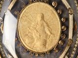 a picture of a gold medal in a glass case