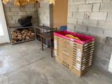 boxes of firewood are stacked on the floor in a garage