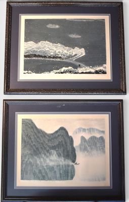 two framed pictures on the wall of a room
