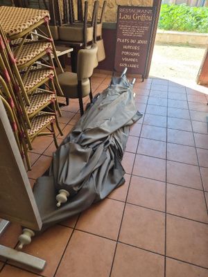 a umbrella that is laying on the floor of a restaurant