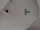 a close up view of a white plate with a hole in it