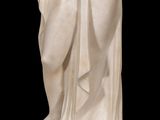 marble statue of a woman holding a bird on a black background