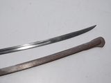 two swords on a white table with a wooden handle