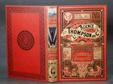 a close up of a book with a red cover on a table