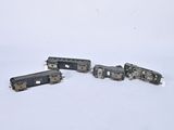 five toy trains that are sitting on a white surface