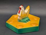 a small yellow and white chicken sitting on a piece of cheese