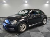 a picture of a black volkswagen beetle parked in a garage