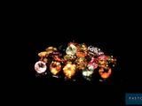 several different colored stones on a black surface in the dark