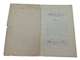 an old book with writing on it sitting on a table