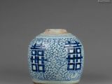 a blue and white vase with a design on the lid