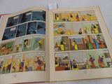 a comic book open on a bed with pictures of people in it