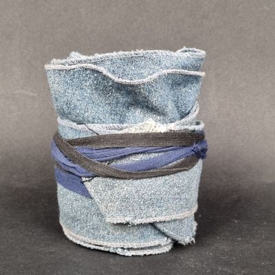 a stack of blue jeans wrapped around each other