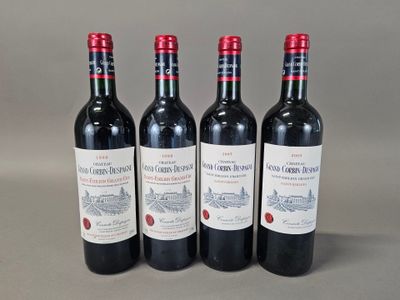 three bottles of red wine sitting on top of a table