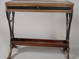 an old wooden table with a glass top and metal legs