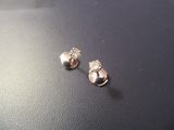 a pair of earrings sitting on top of a table