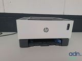 a white printer sitting on top of a table next to a wall
