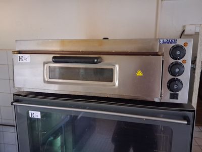 a silver oven sitting on top of a counter in a kitchen