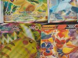 four pokemon cards are sitting on top of each other on a table