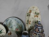 many different types of vases and plates on the table