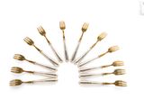 several forks and spoons arranged in a circle on a white surface