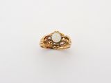 an image of a gold ring with a white stone in the center