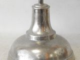 a silver clock that is on top of a metal stand