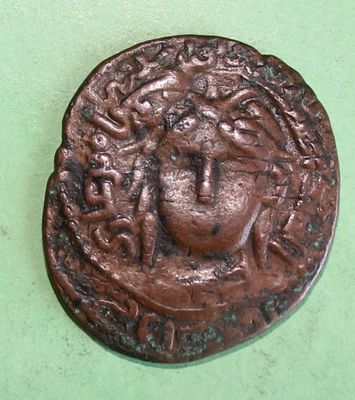 a close up of a coin on a table with a green background