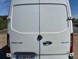 the back of a white van parked in a parking lot