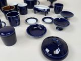 a lot of blue and white dishes and cups on the table