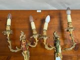 four antique wall sconces on a wooden table with a label on it