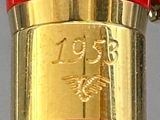 a close up of a red and gold pen with a clock on it