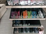 a lot of pens and pencils on the shelves in the store