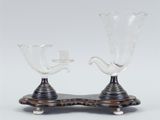 two clear glass vases sitting on top of a wooden stand